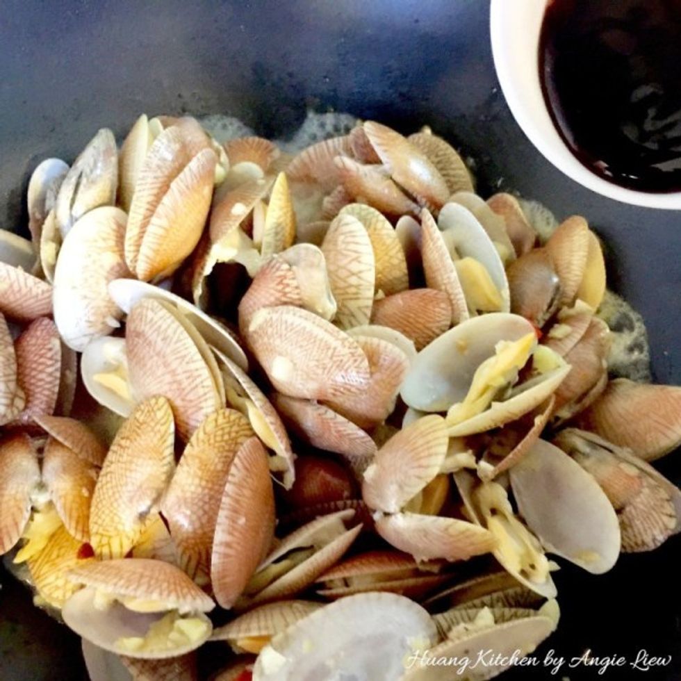Then add in oyster sauce and toss the clams for about 1 minute until the sauce is well mixed into the clams.