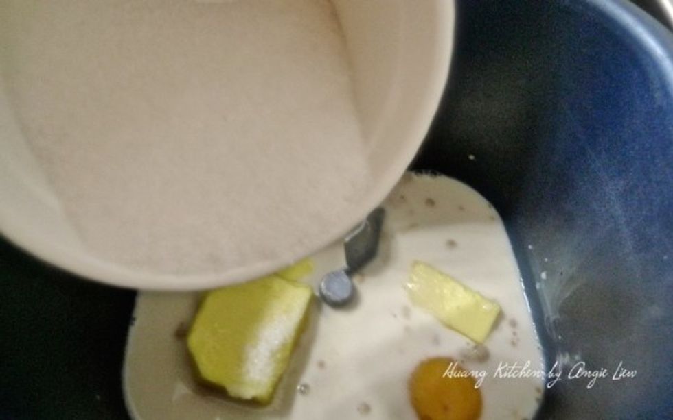 Then add in the warm milk. (Warm quickly in the microwave oven). Add in one egg followed by the softened butter. (Make sure it's softened to room temperature). Next, add in the sugar.