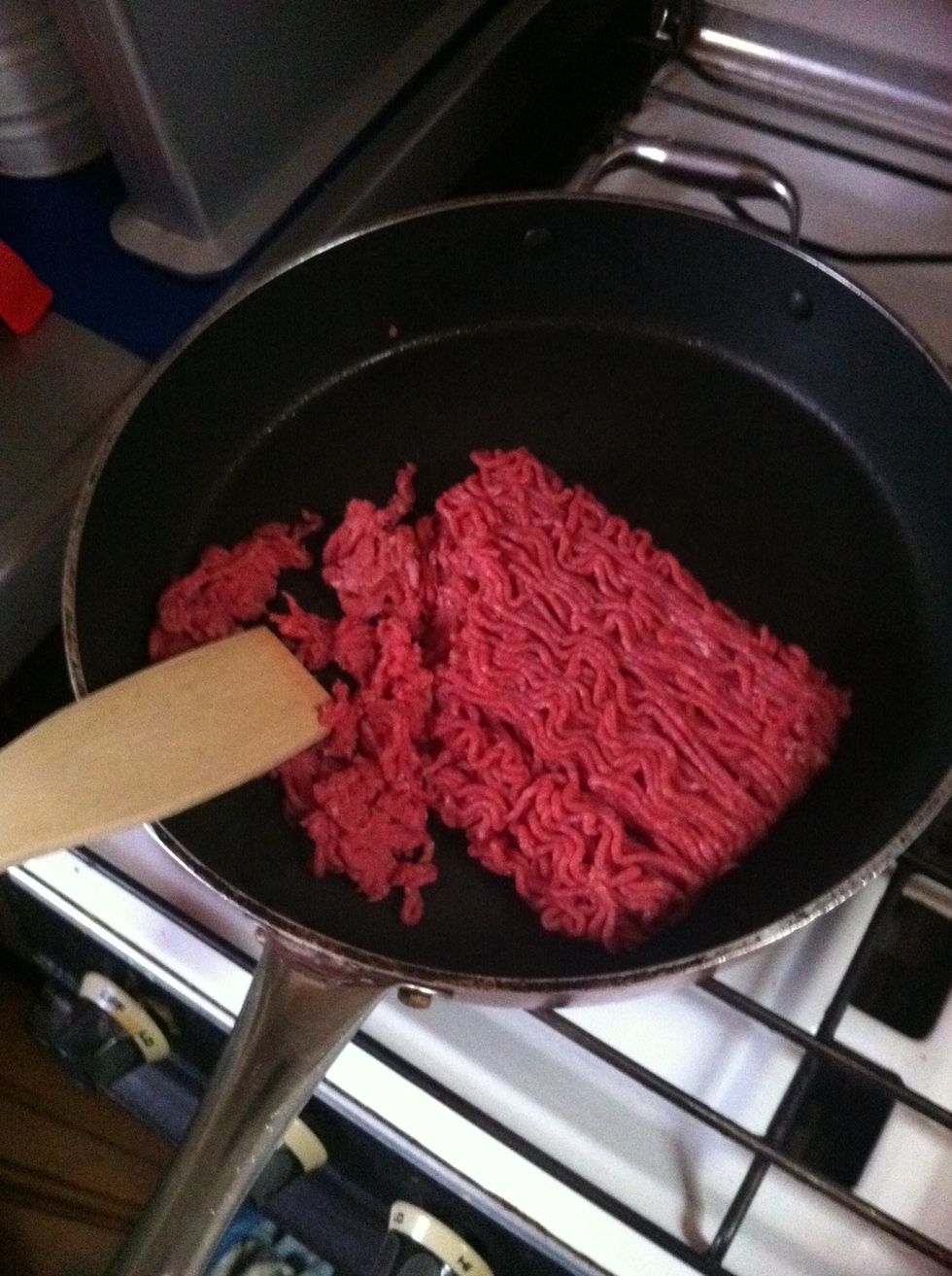 Then add mince into a pan and stir with a wooden spoon to break up all clumps.