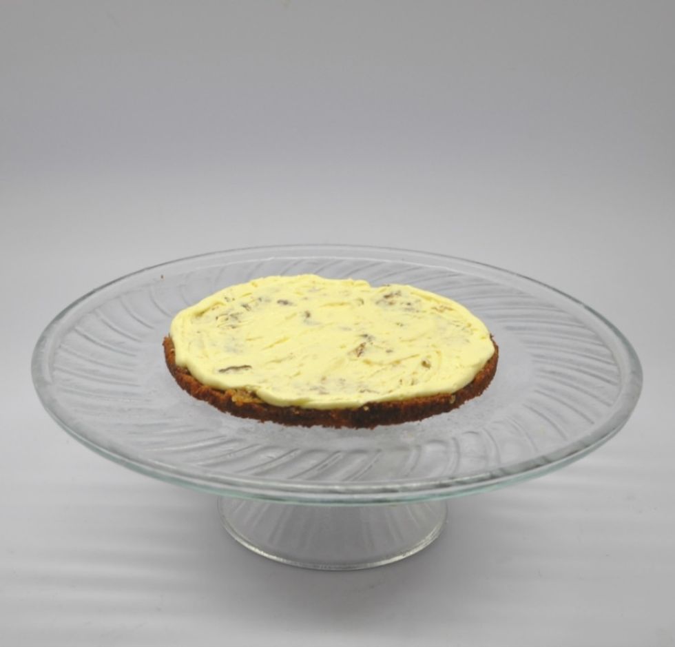 Then add more icing in the centre and spread to the edges. It's just a thin layer of frosting; but not too little as well! Repeat this until you've reached the outermost top layer.