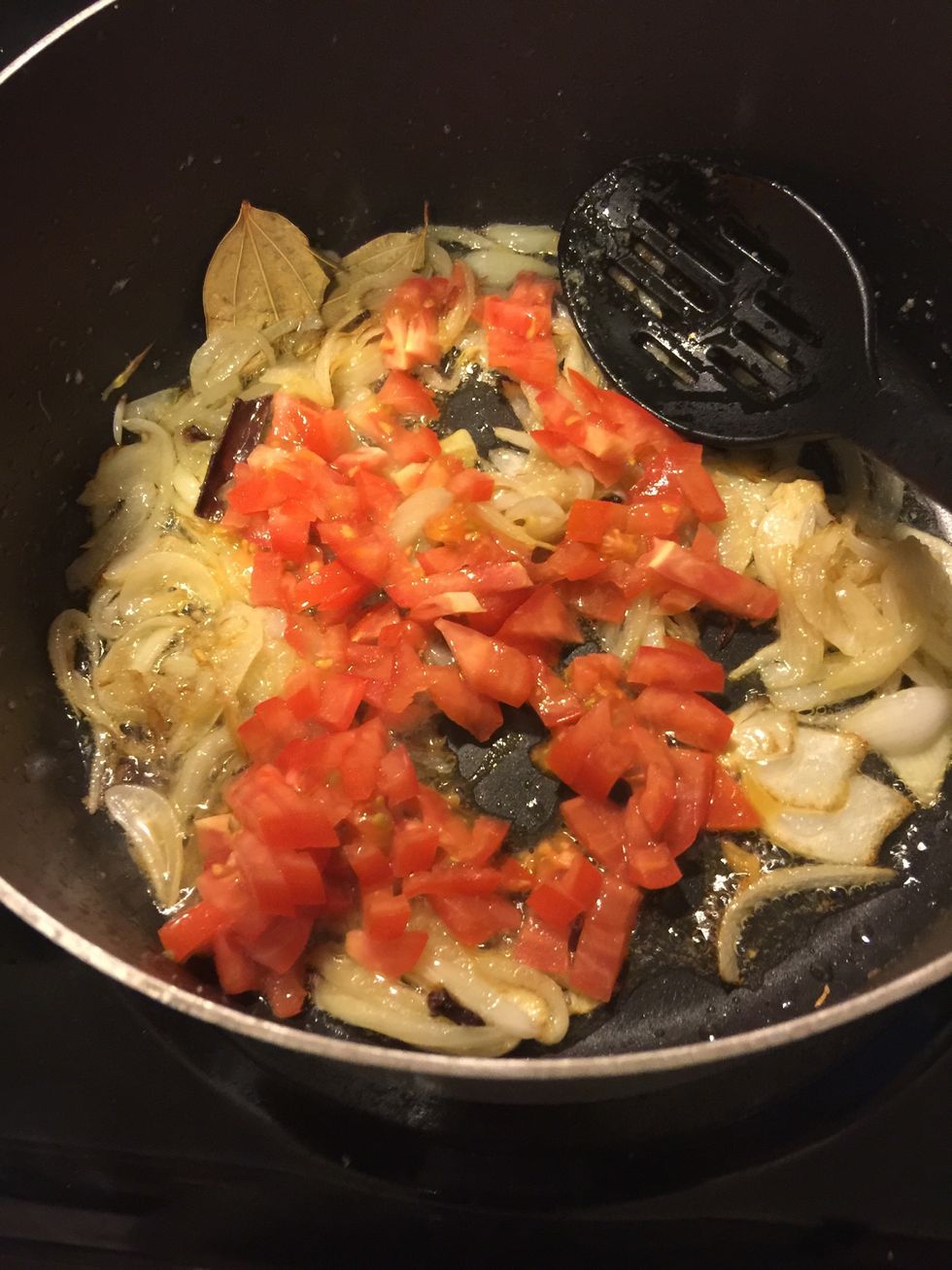 Then add one chopped tomato, and let it cook till the tomatoes are tender and well cooked.