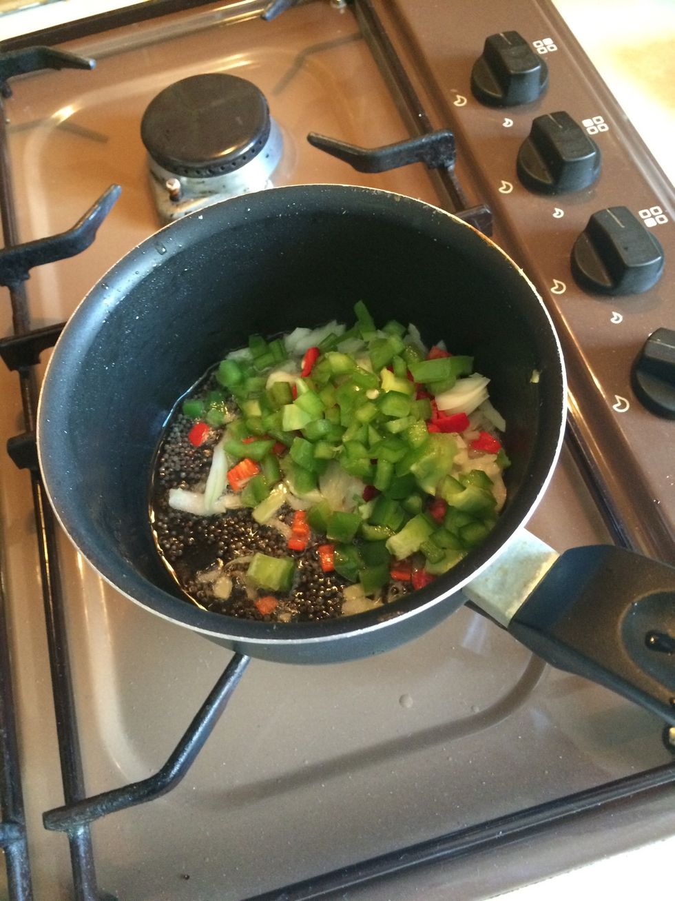 Then add onions, green pepper and red Chilli. Let is soften
