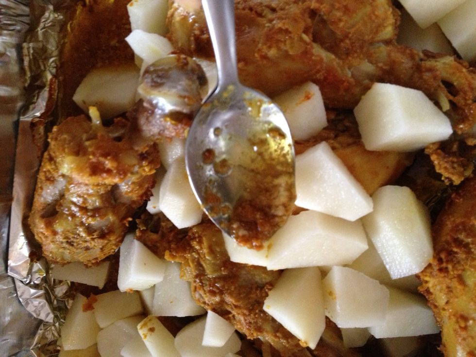 Then add potato you can put bigger chunks but I prefer them smaller.  Now get the melted butter from bottom of tray using a spoon pour over your potatoes.