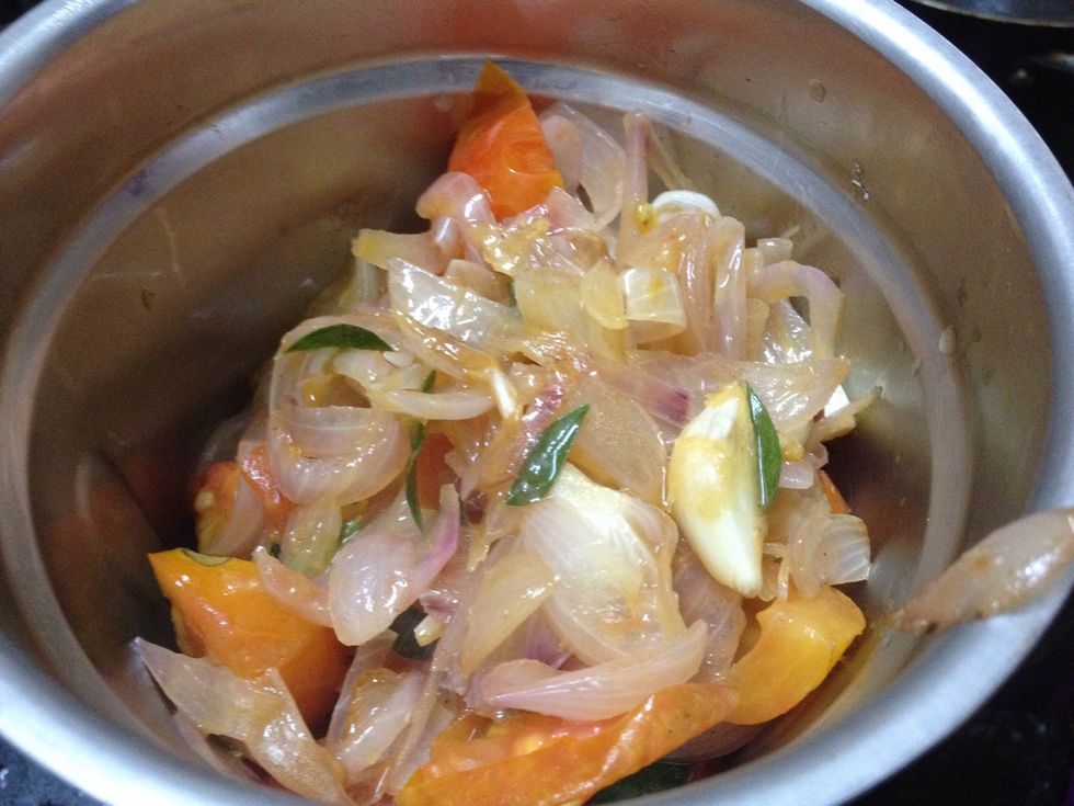 Then add saut\u00e9 tomatoes onions garlic and curry leaves