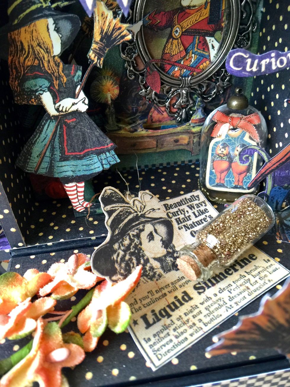 Then add some layers and embellishments on the top of the square box that contains a mini album (tutorial in another snapguide).