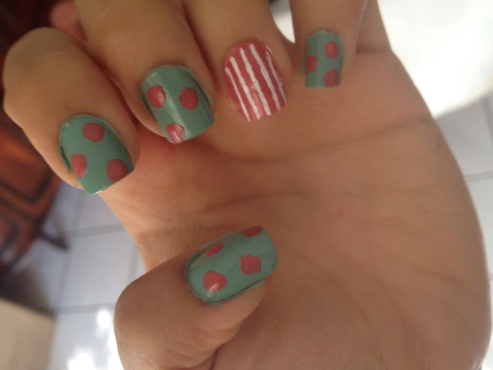 Then, add some light pink dots on the other nails