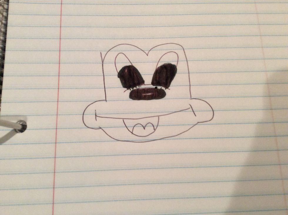 Then add the eyes by shading them in with a marker just like the nose