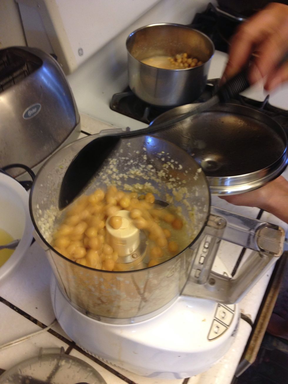 Then add the garbanzo beans with as little of the water as possible