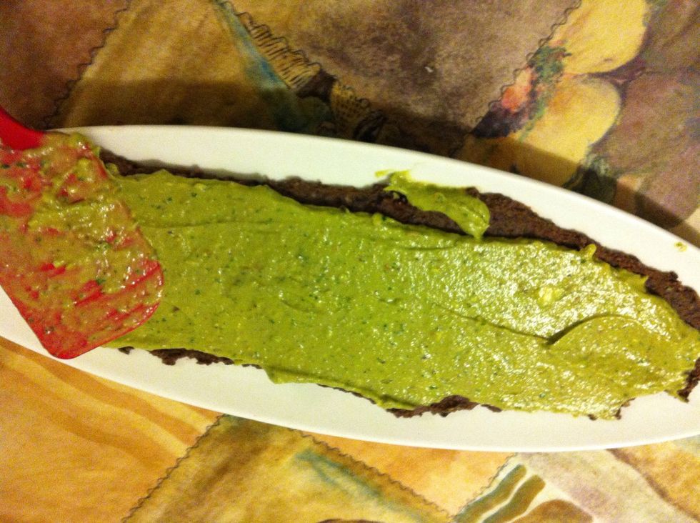 Then add the guacamole that I also did in the blender with cilantro and lime juice, Also to be spread flat Creating your second layer.