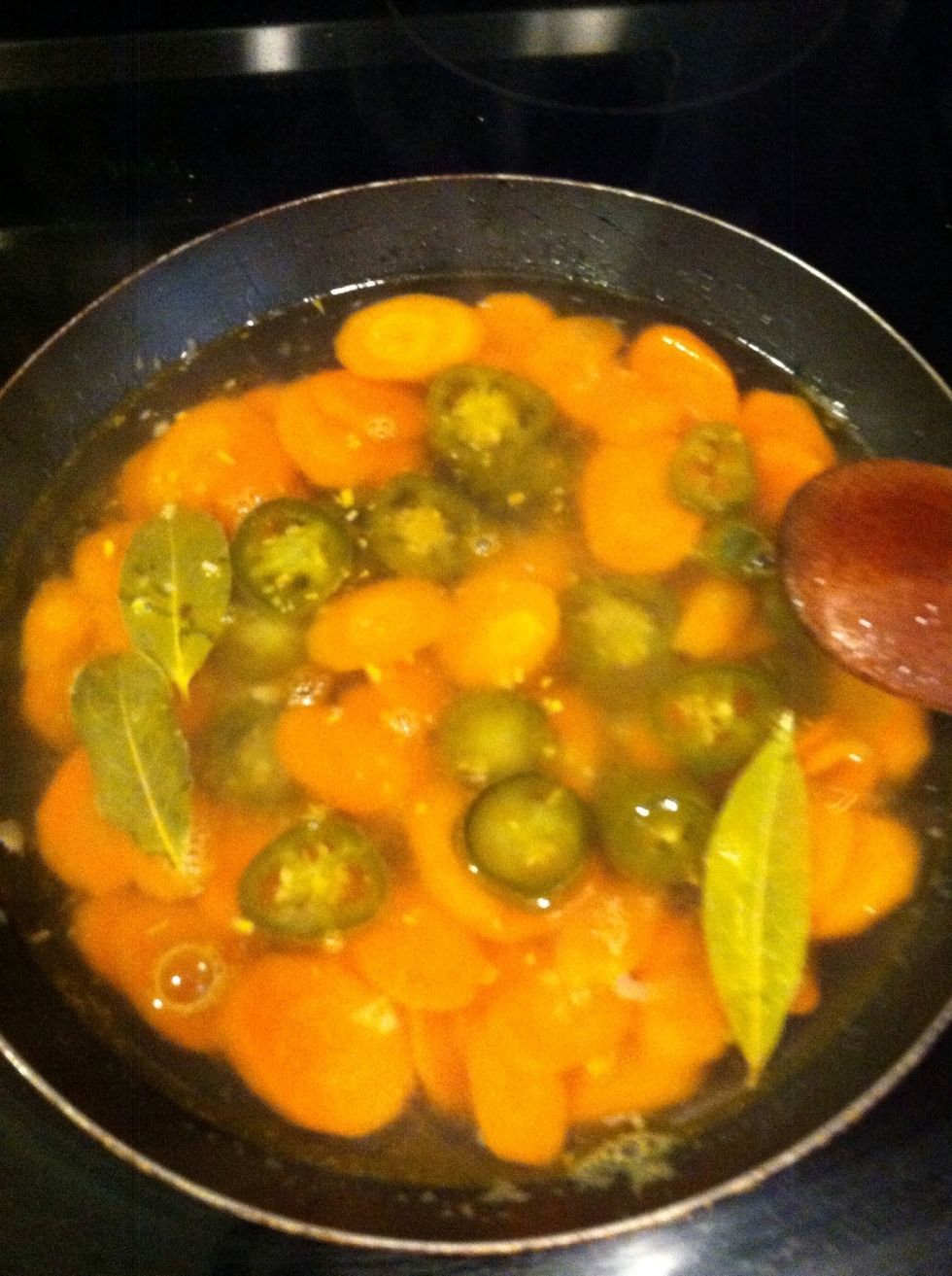 Then add the water, and chopped jalape\u00f1os and simmer for about 5 mins, if you like your carrots a little softer leave them a little longer. I like mine a bit a little crisp.