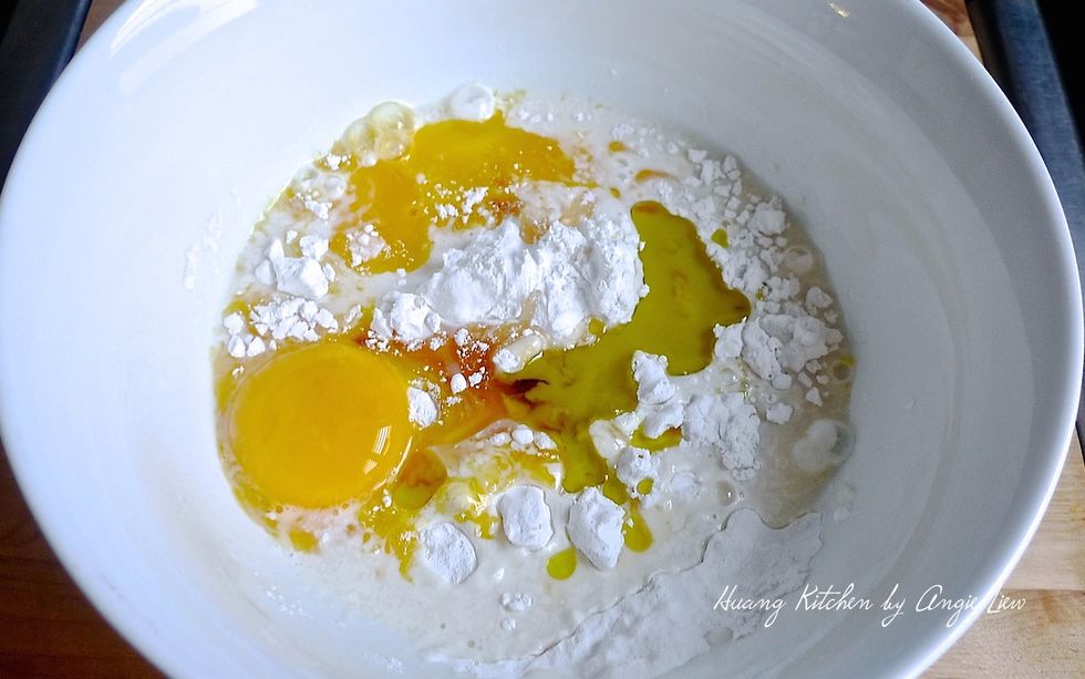 Then add the wet ingredients into the dry flour mixture starting with egg yolks followed by vanilla extract, milk and vegetable oil.