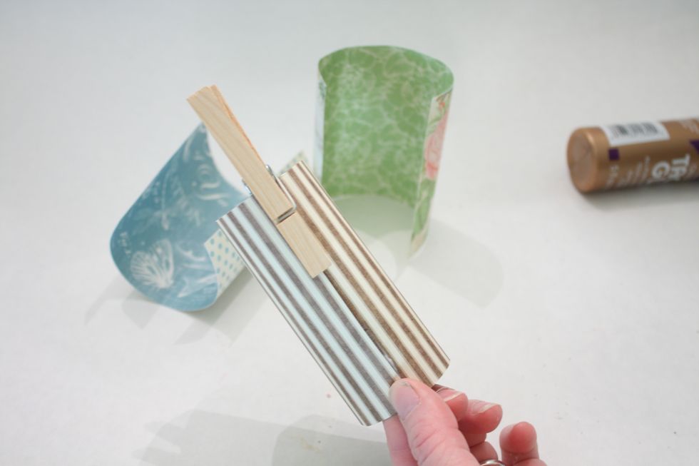 then, add to the roll, with the glued side overlapping-then add a clothespin, bulldog clip or paper clip to hold together at each end