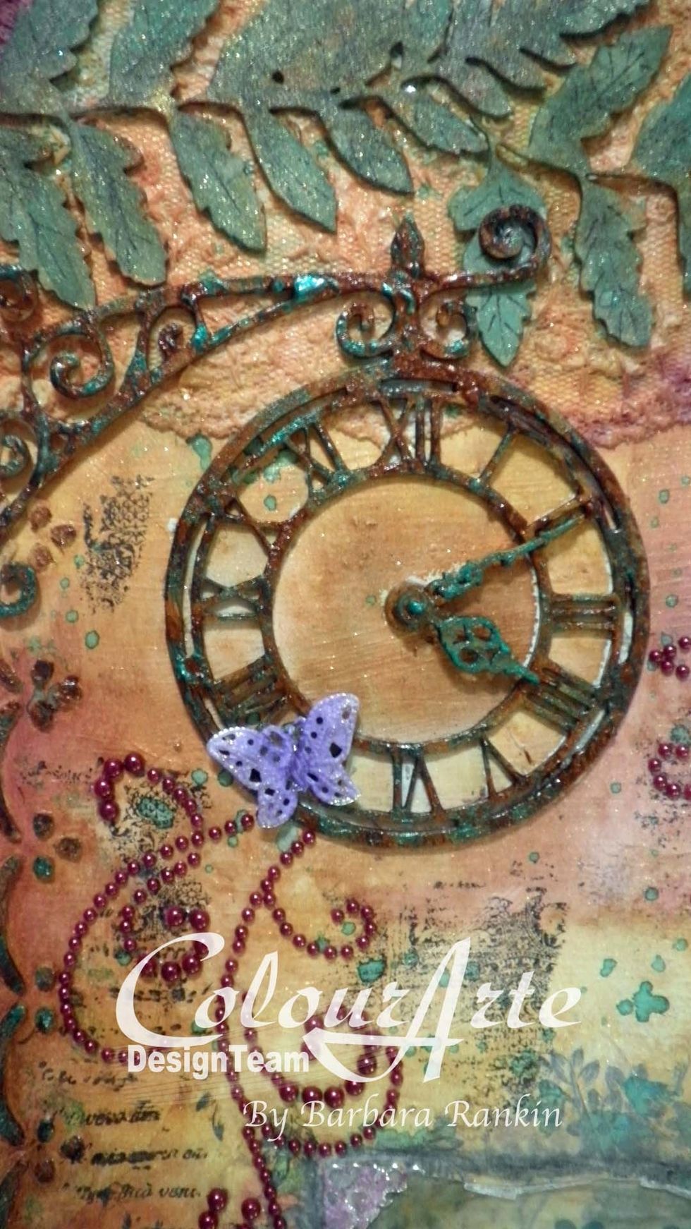 Then add Want2Scrap wine pearl swirls stickers to page around the clock. Color the metal filigree butterfly with white gesso, then ColourArte Radiant Rain Plum Crazy dauber, then adhere to clock.
