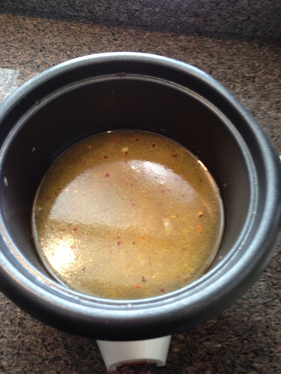 Then add your 2 cups of water and give it a good stir to dissolve the cube