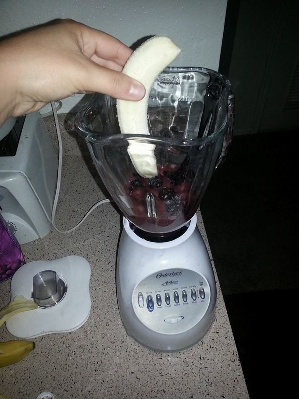 Then add your whole banana, put top on blender, and blend until smooth.