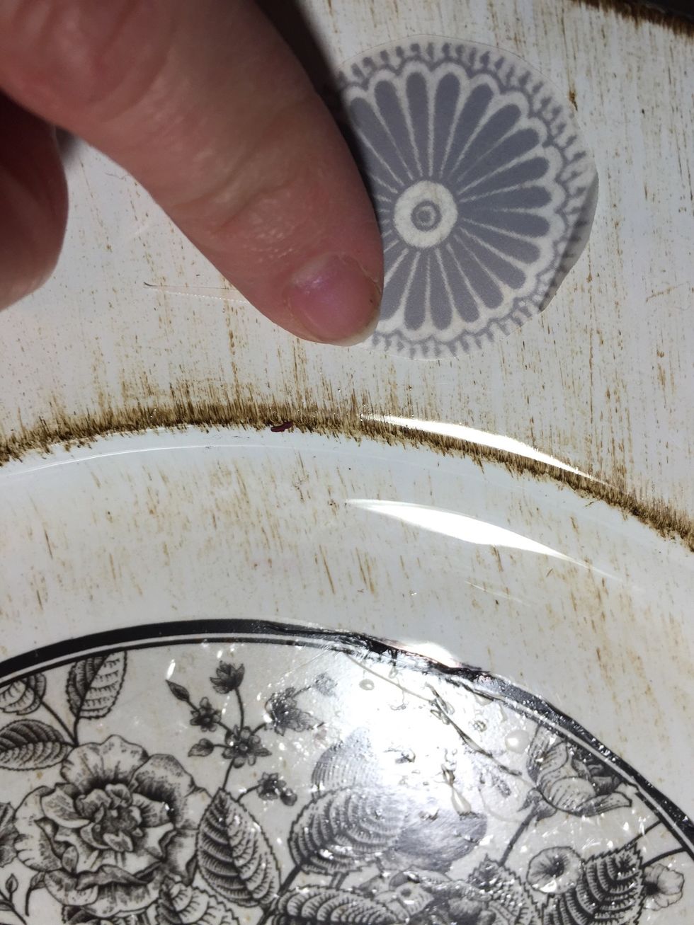 then adhere face down to the surface, rubbing with your finger or the wooden stick to make sure rub onz transfers to surface.