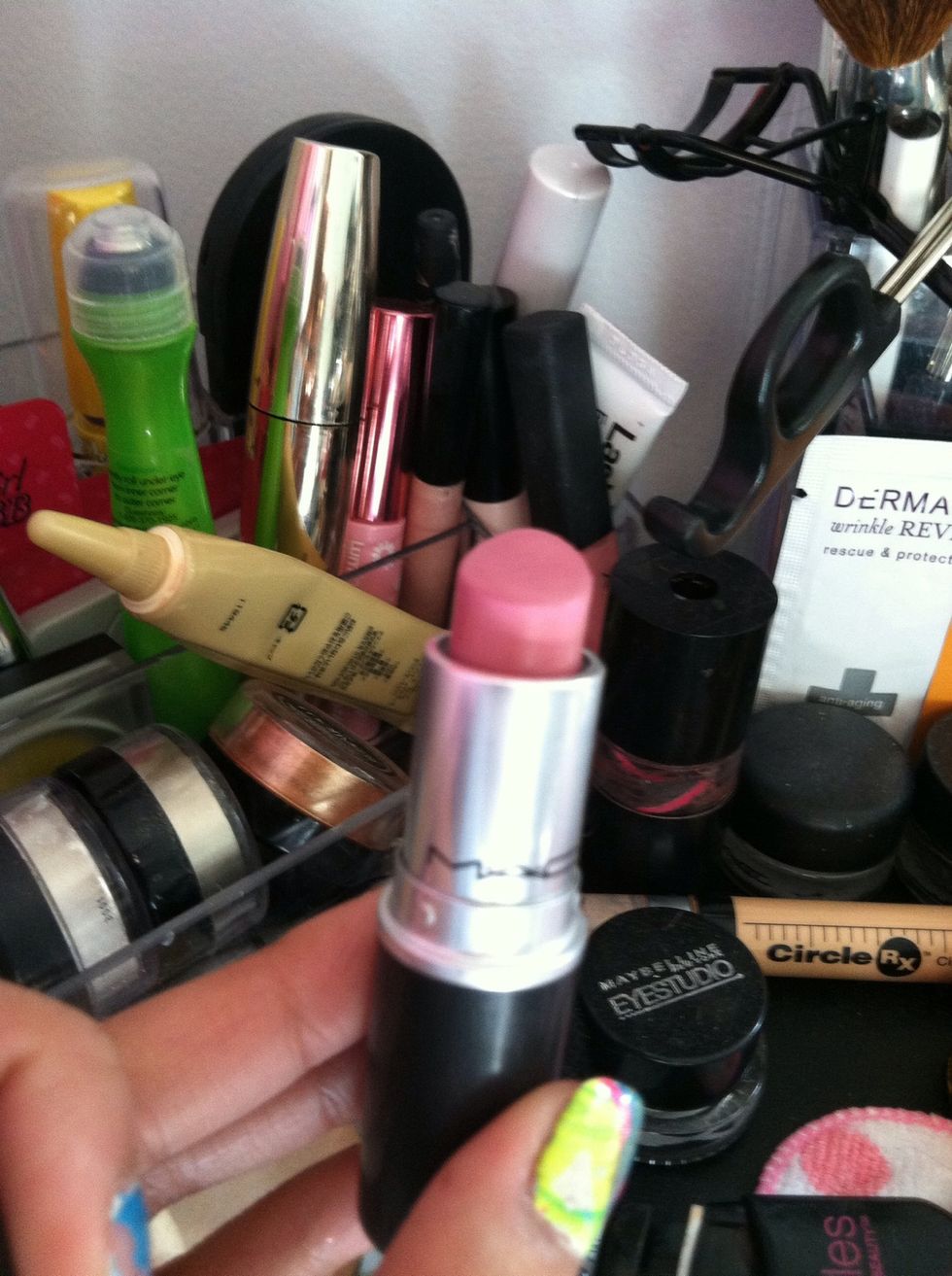 Then apply a lighter pink lipstick using your brush to the rest of your lips that are not colored yet. . I used this Lipstick by MAC called snob.