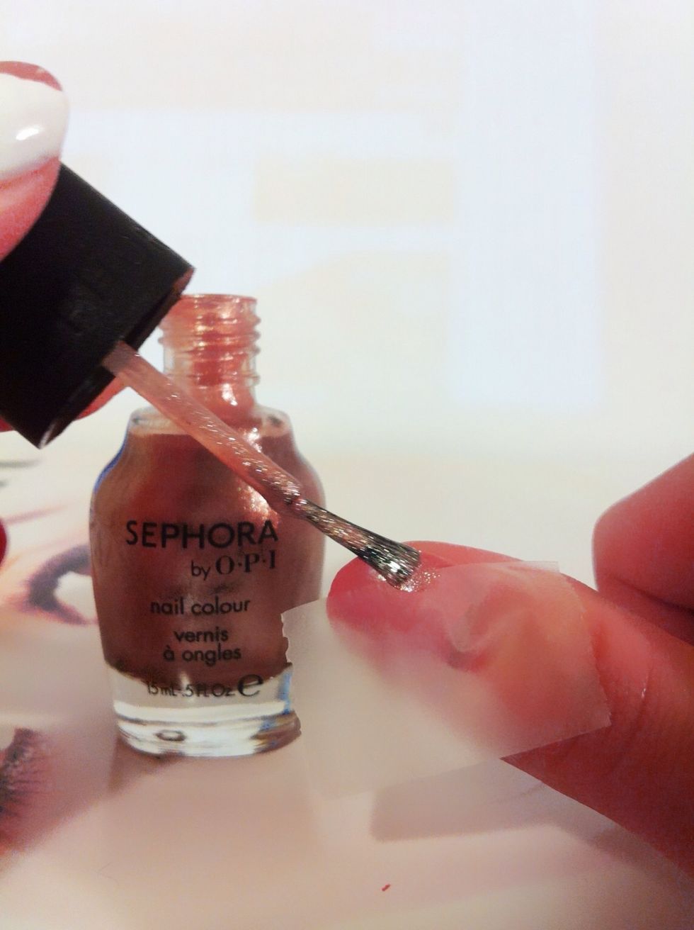 Then, apply the golden color polish on the uncovered area.