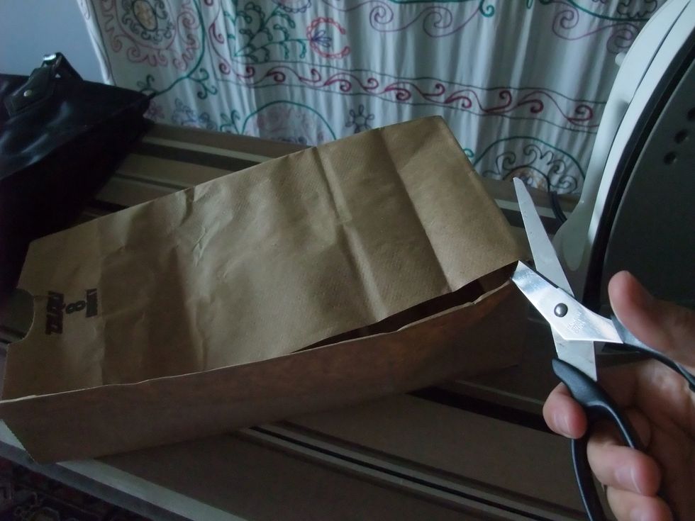 Then, apply the scissors to the paper bag, like so.