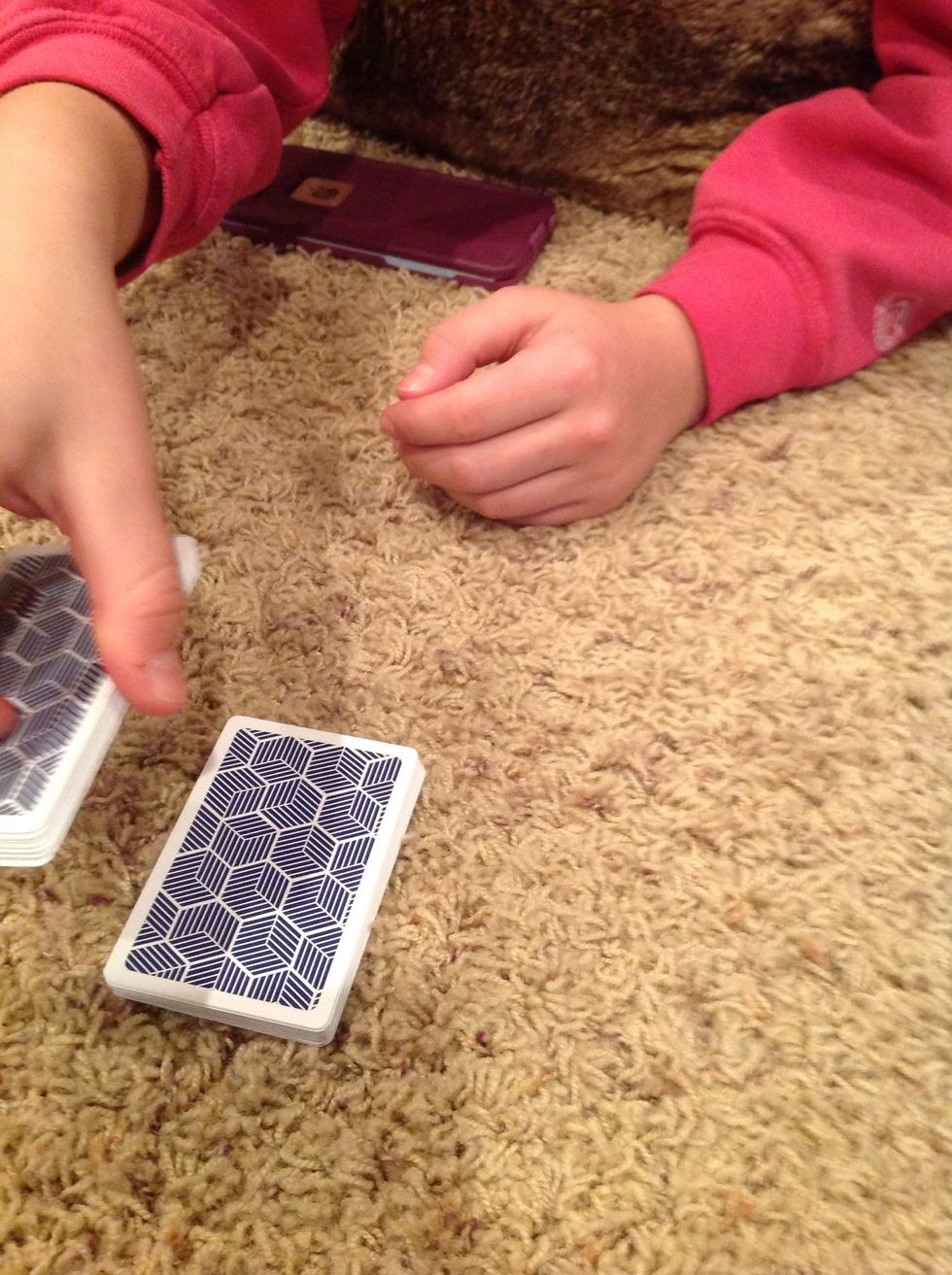 Then ask the volunteer to split the deck. Take whatever they split off the top and place it on the bottom. (Now you know that their card is somewhere in the middle of the deck.)
