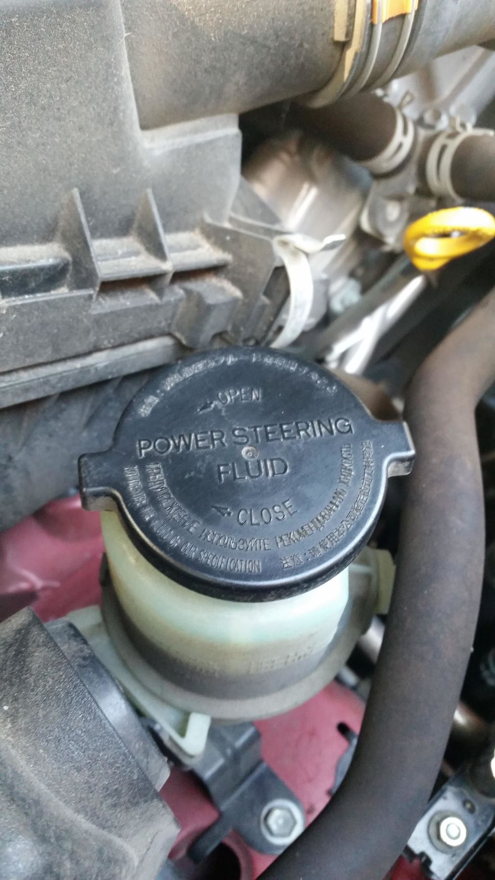 Then before you leave the engine cabin you check the power steering fluid.