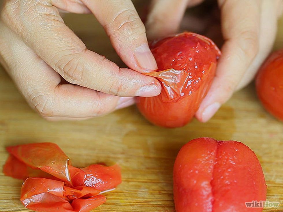 Then begin to peel the tomato skins off to put into food processor, then doth forget to discard your skins.