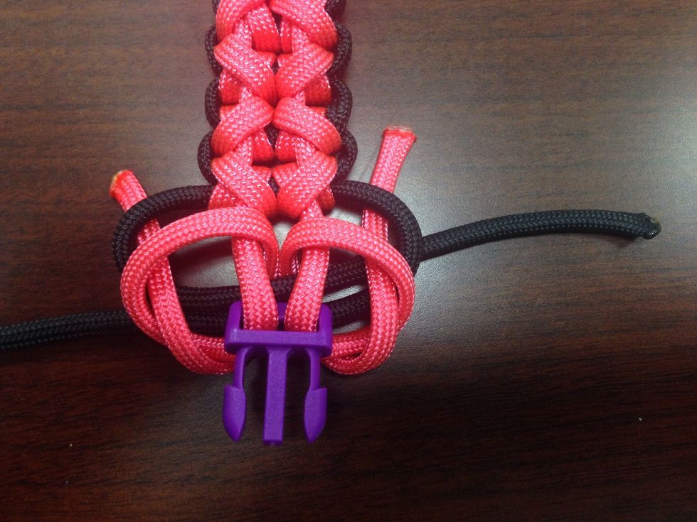 Then bring them back toward you under the two back stands and the pink one, then under the loop you made in the last step and the top of the black loop.