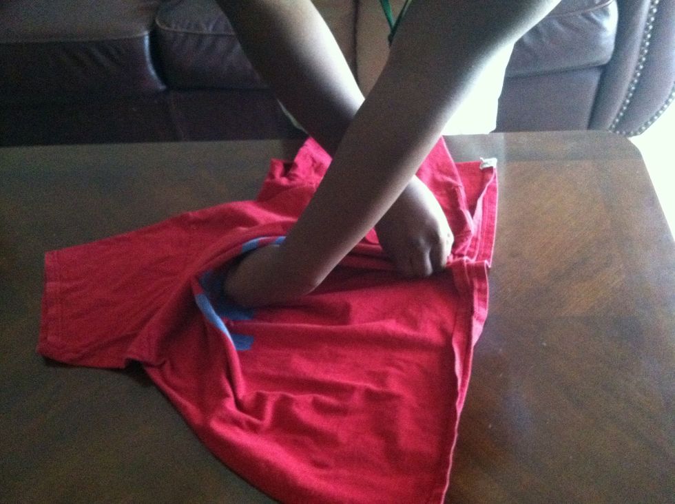Then bring your right hand directly behind your left hand and pinch the shirt again.
