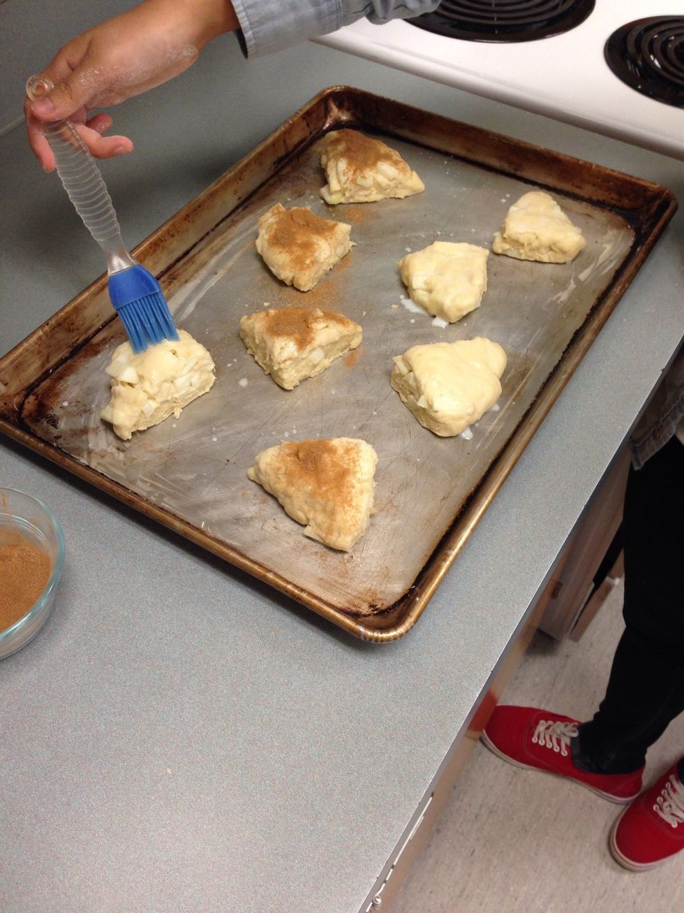 Then brush scones with milk and sprinkle on a mixture of 2mL of ground cinnamon and 30mL of sugar