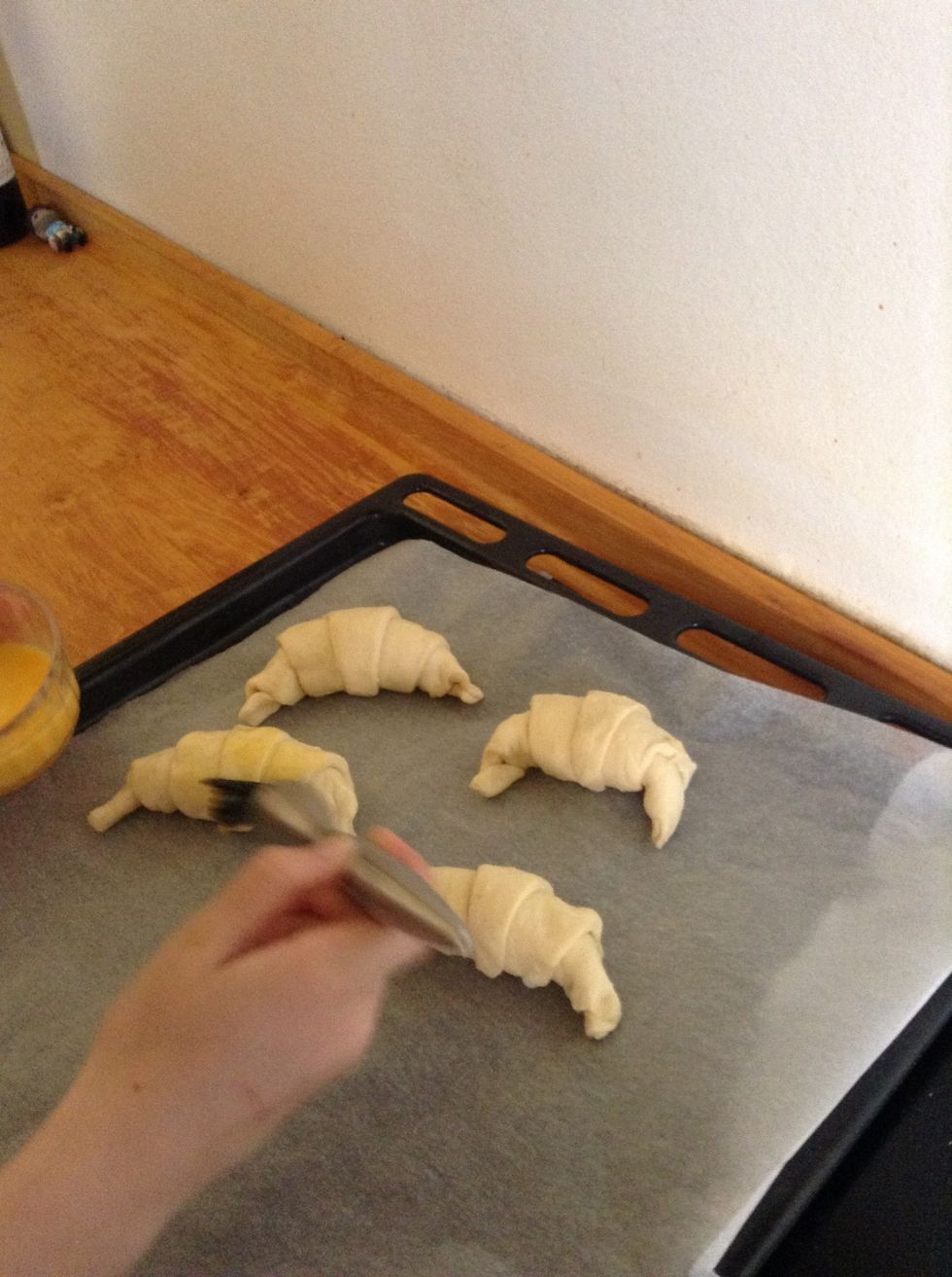 then brush the egg all over the croissants.