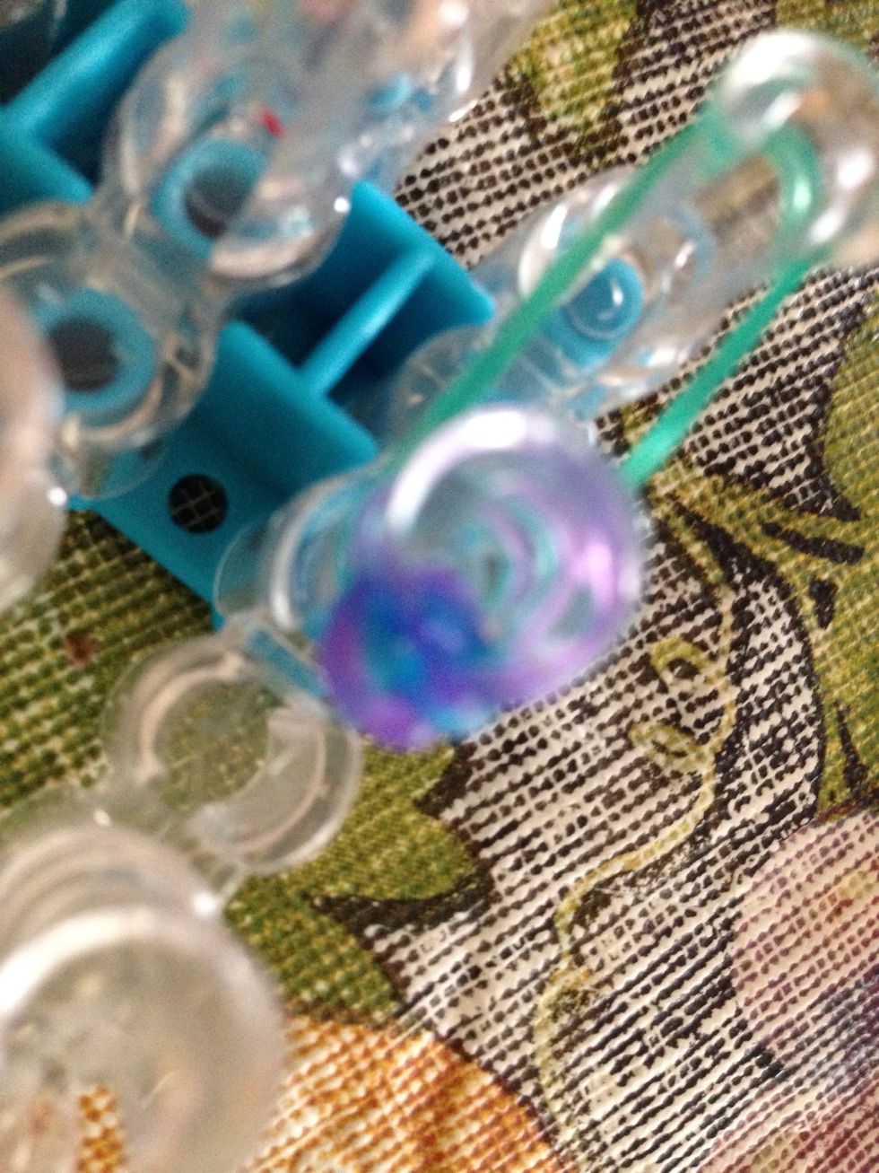 Then by holding the middle bunch loop it on to one peg