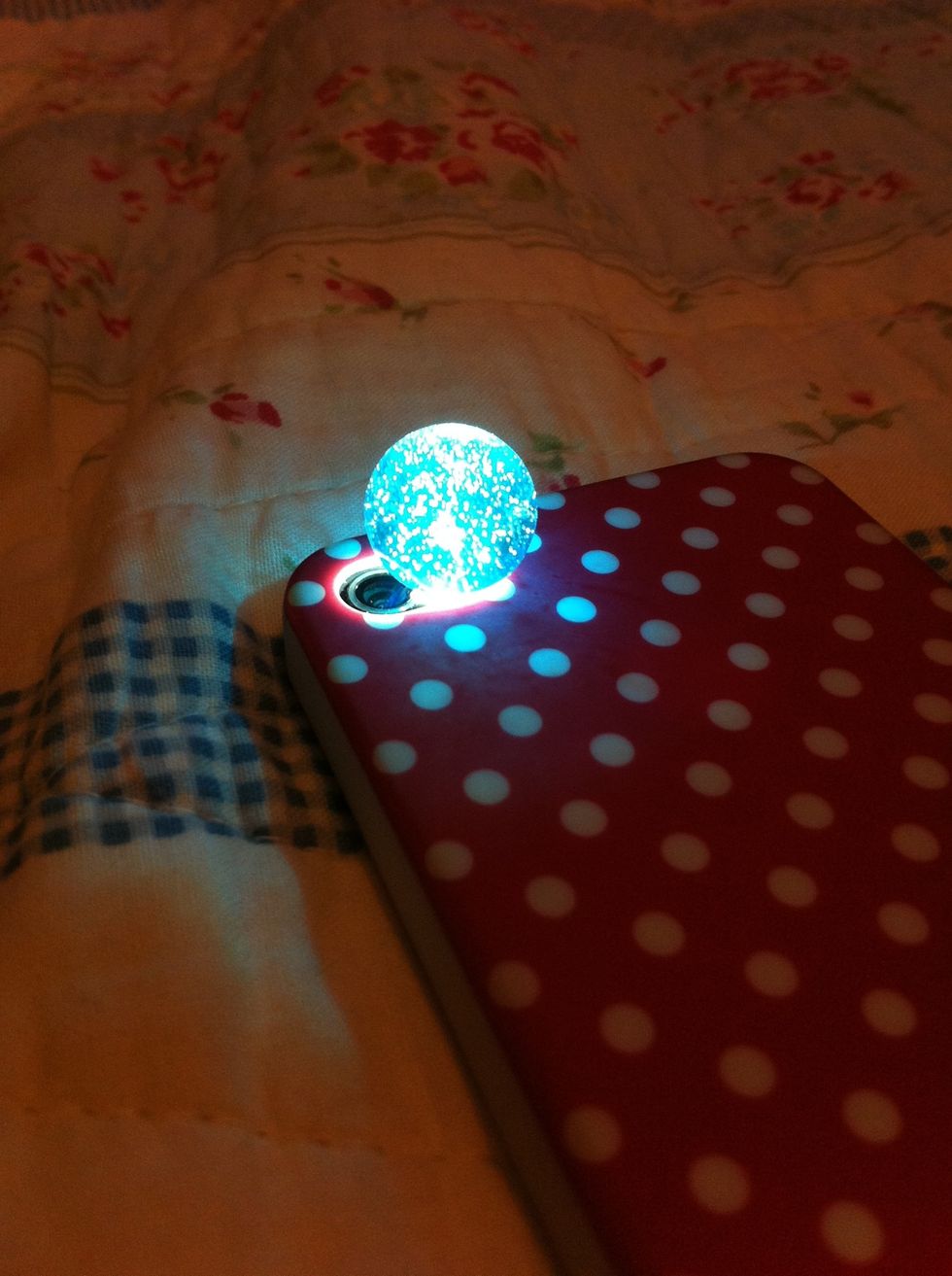 Then carefully, place your marble on the flashlight!