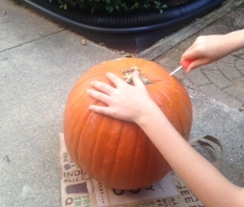 Then carve top off of pumpkin.