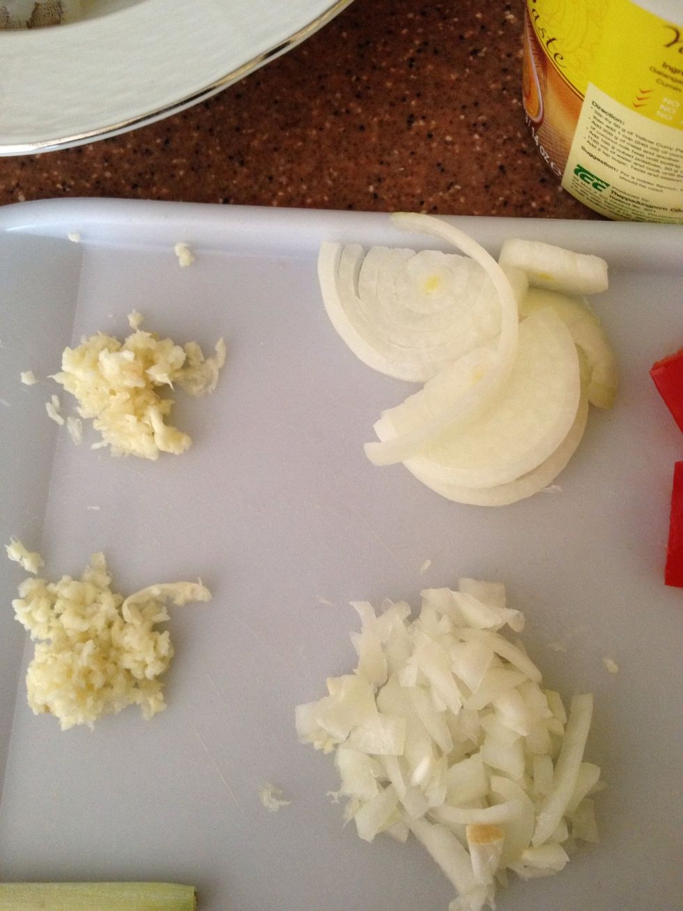 Then chop half from the onion you have again ,like so.get half from your chopped garlic too
