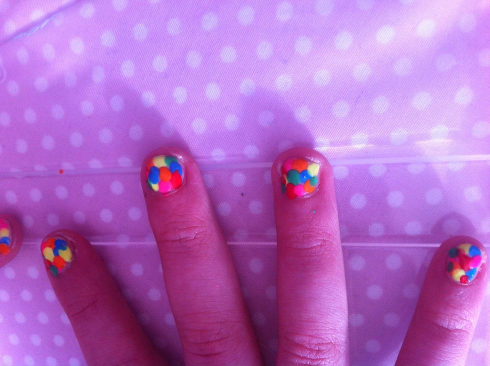 Then clean up your nail by dipping a cotton bud into acetone or nail varnish remover. Then once dry give them a clear top coat, giving them shine and protection