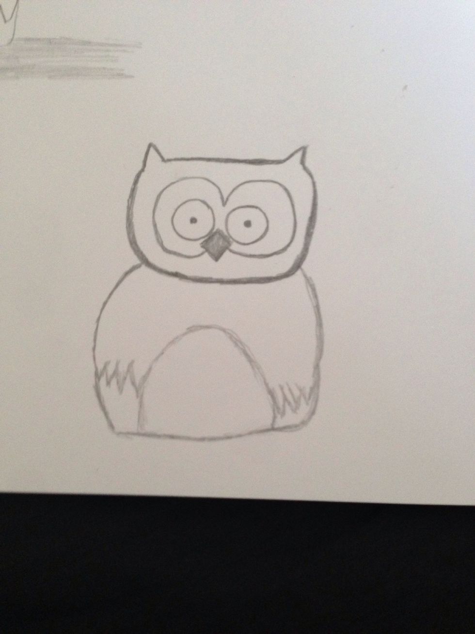 Then connect the wings by the feathers with half an oval. After that draw a line along from the base of the oval connecting up to the wings