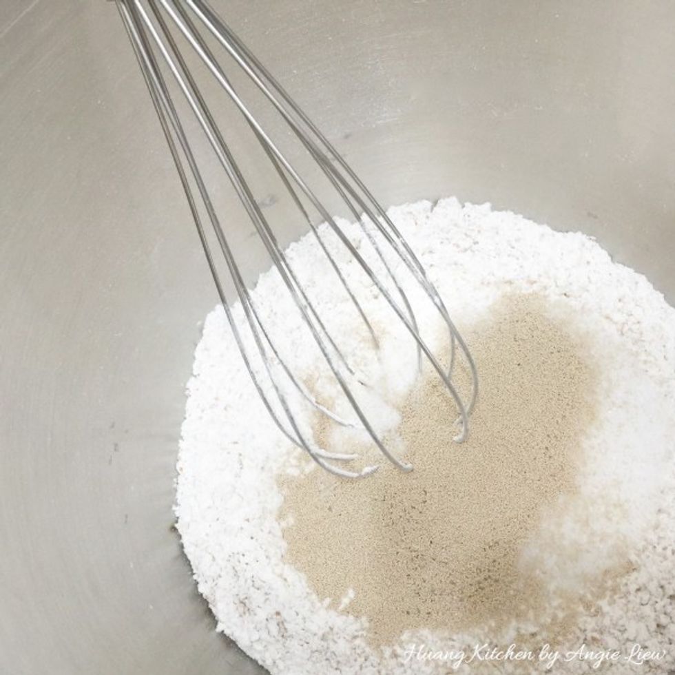 Then continue to add in sugar and the dry yeast. Mix everything together.
