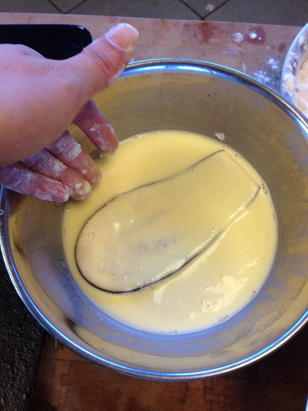 Then cover the eggplant in egg wash