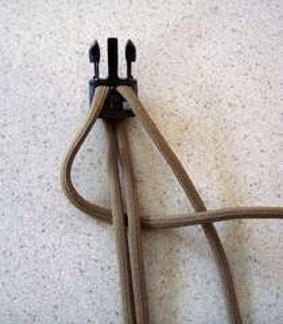 Then cross the cord behind the doubled one.