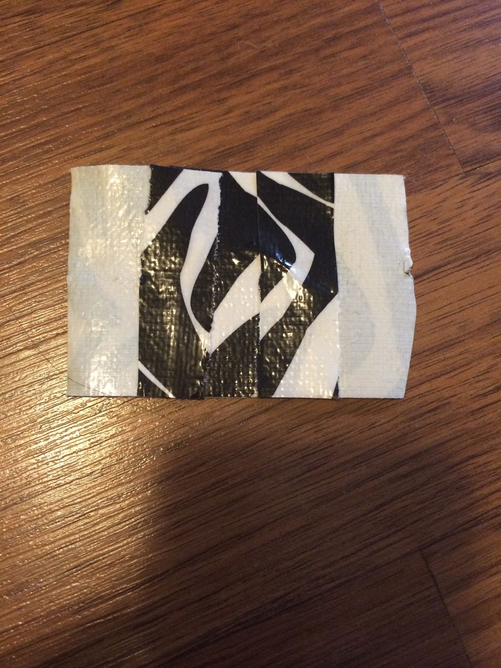Then cut 2 pieces of duct tape and put it on each other but leave some stickiness to go on the toilet paper roll. Do 2 of these for both ends of the roll.