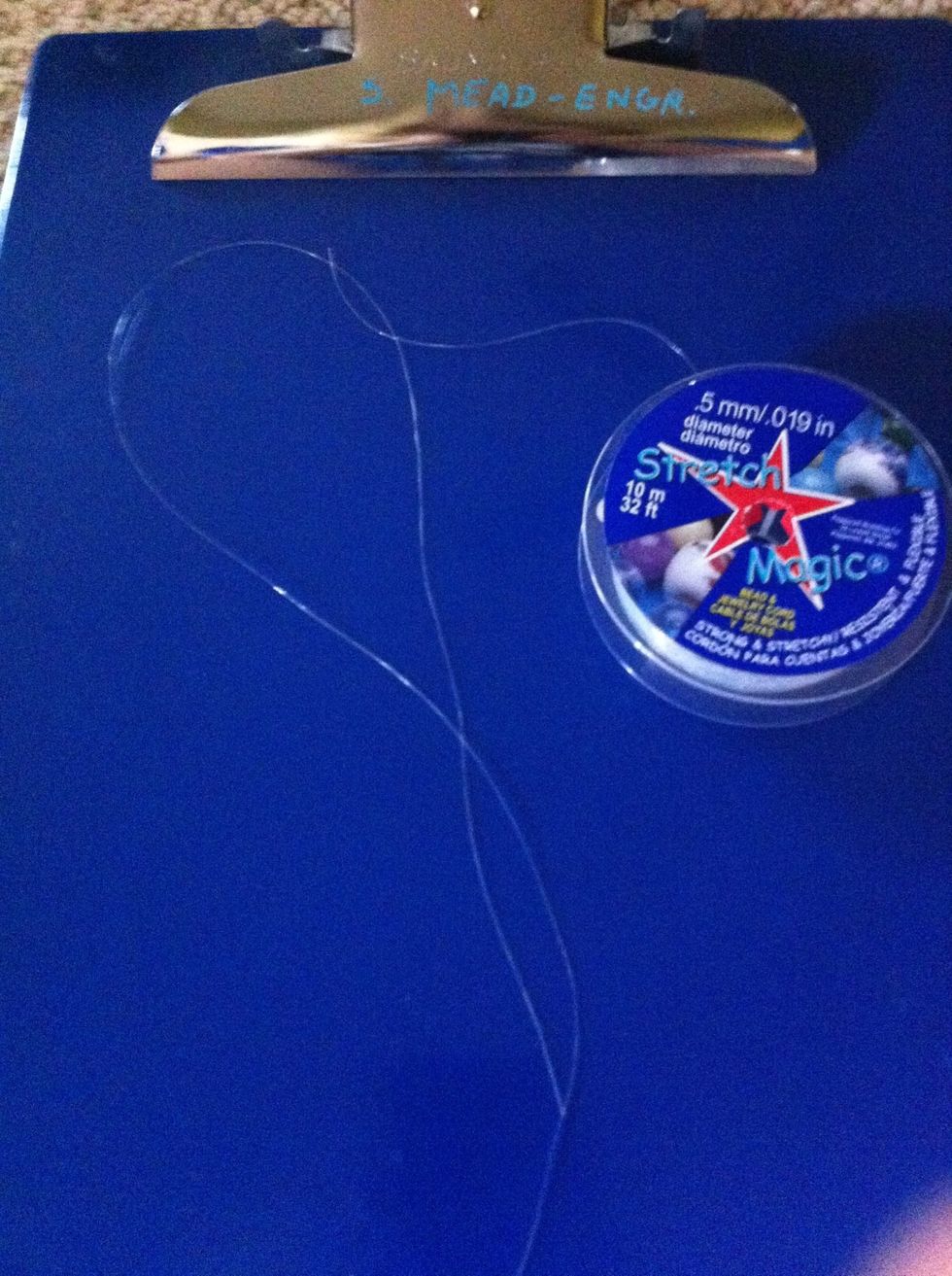 Then cut a piece of your clear string the same size as your yarn.