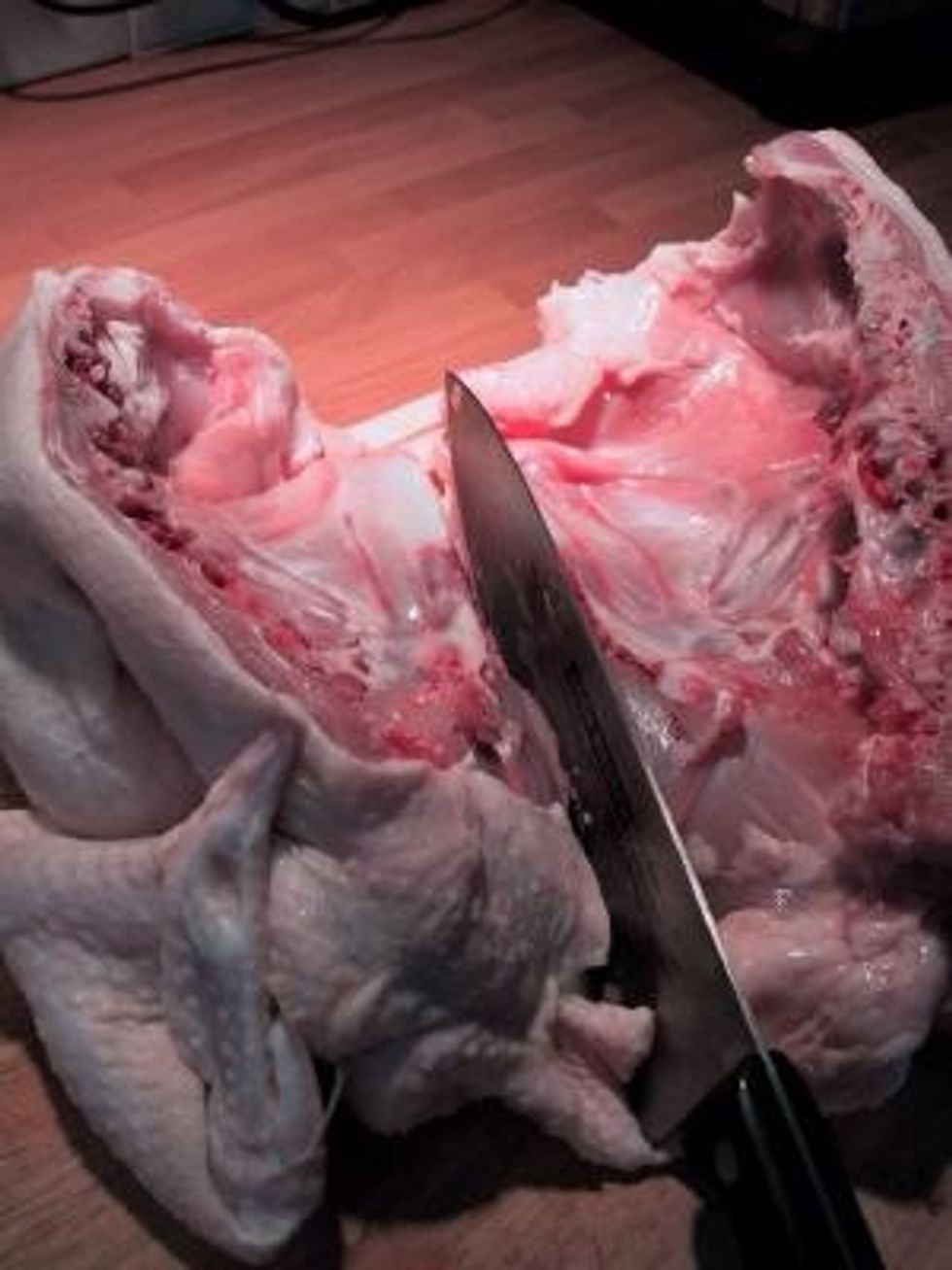 Then cut in half along the breast from the inside