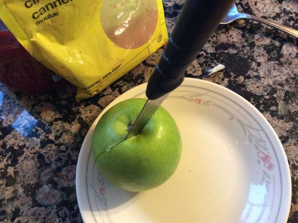 Then cut the apple with the knife into 8 sections and cut out the core of the apple with the knife