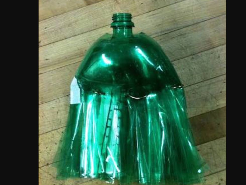 Then cut the bottles into strips and cut the lid off of one of the bottles