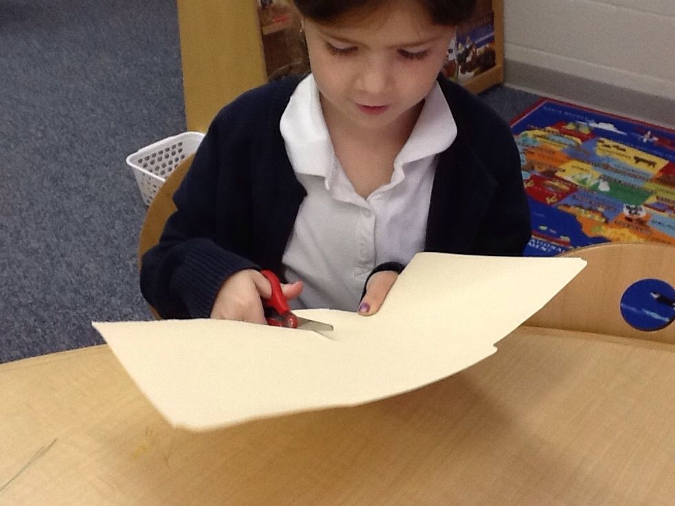 Then, cut the cardboard into two pieces. One piece is for the front of the book.  One piece is for the back of the book.