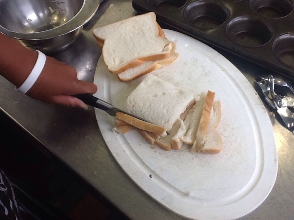 Then cut the crust off the side of the bread! And butter it