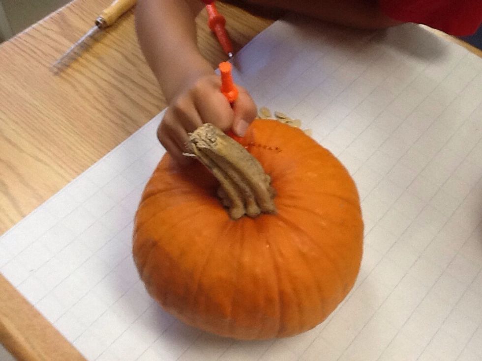 Then cut the pumpkin on the top.