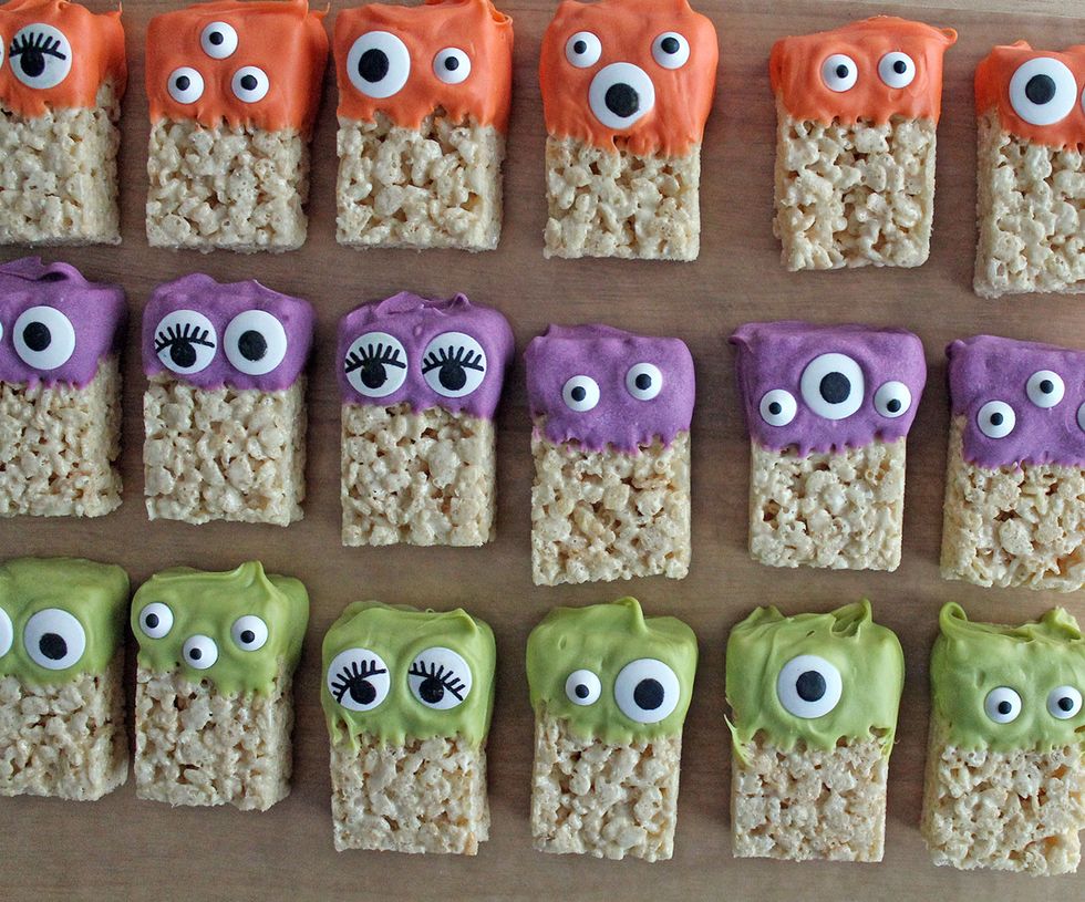 Then dip one end of the Rice Krispie treat to cover about 1/3 to 1/2 of it. Press the eyes into place. Be creative...monsters can have any number of eyes!