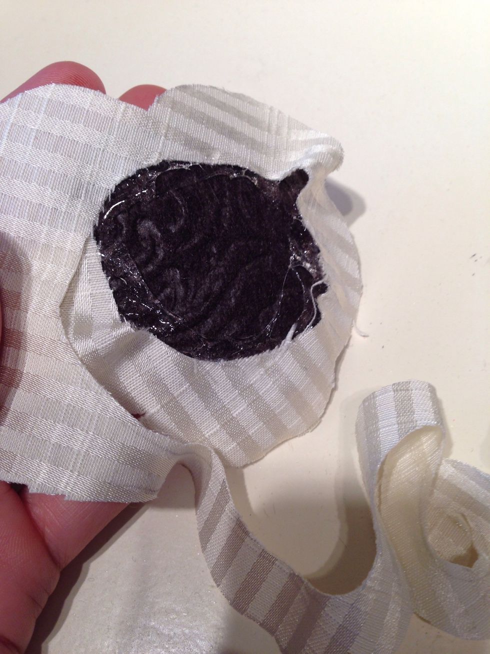 Then do the same with the next layer. Going in a circle, Do not lay it flat on the glue. Just adhere one of the edges to the glue.