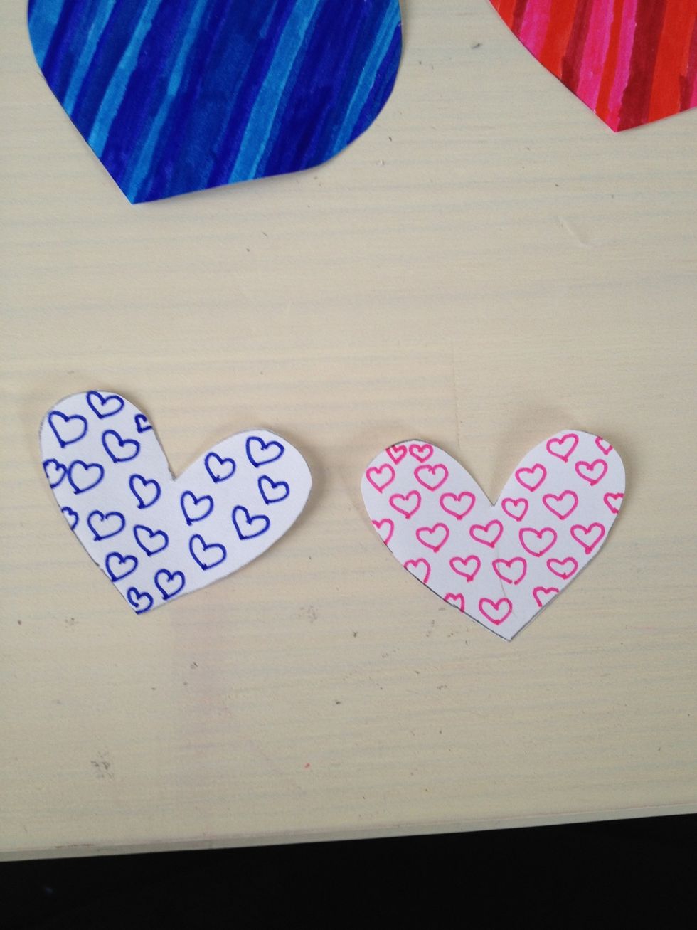 Then draw a pattern in the smaller hearts and cut them out.